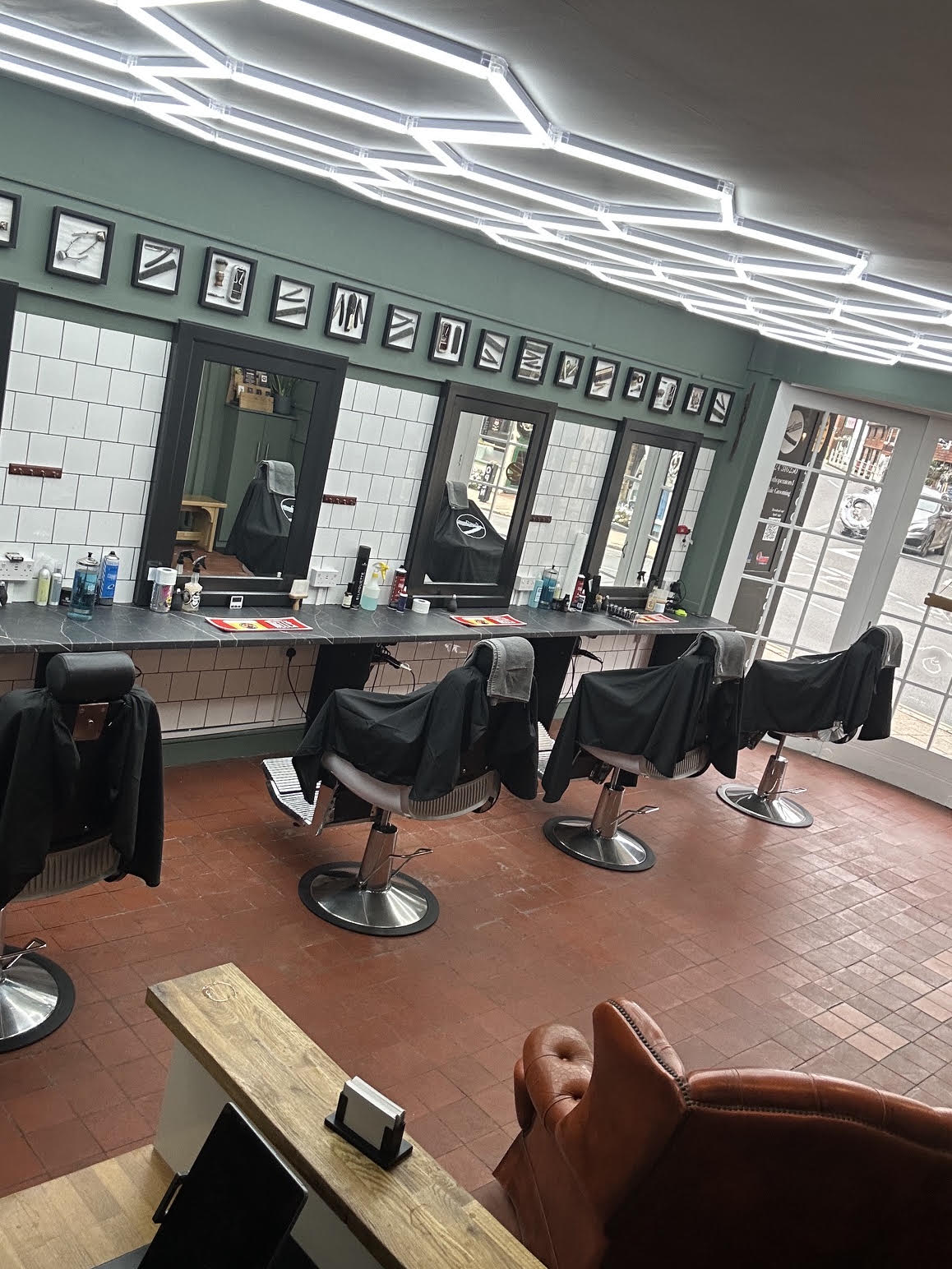 Barber chairs, mirrors and framed prints along the shop